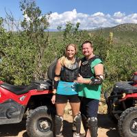 Karin and her husband riding ATVs in the deserts of Mexico
