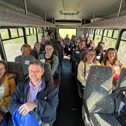 Teachers riding on a bus, touring GUC facilities