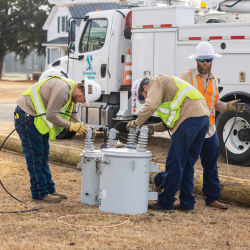 Lineworker Third Class Tyler Bradshaw and Lineworker Second Class Hunter Forrest prepare new transformers to be installed after a pole is replaced on David Nobles Road.