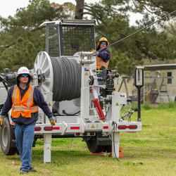 GUC Electric crews run 12.47-kv lines on the new steel poles along Highway 43. 