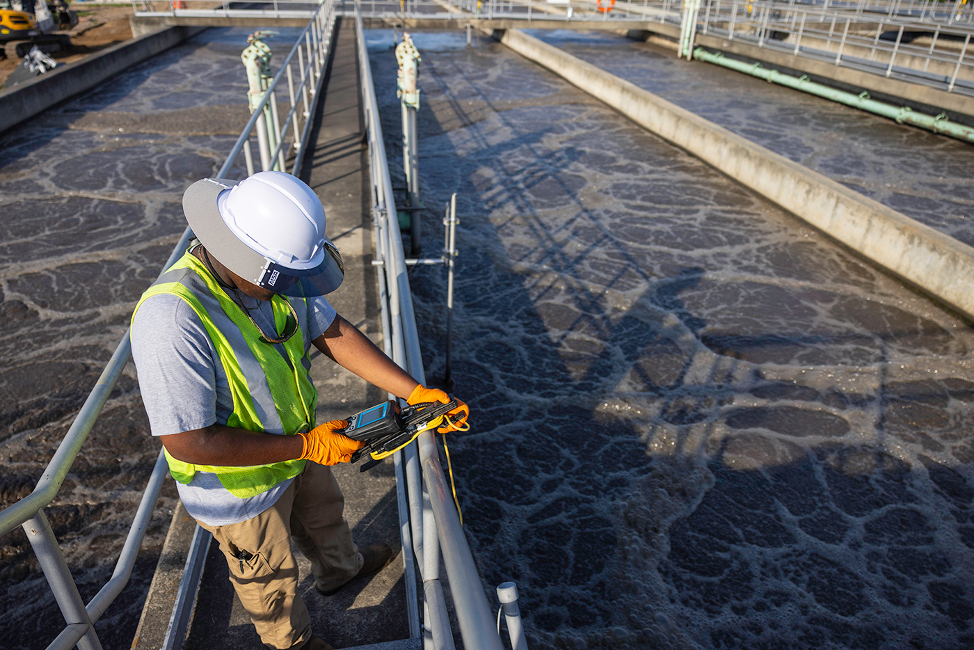 Pre-Apprentice Jayden Robinson checks the dissolved oxygen level in aeration basin five with a handheld meter.