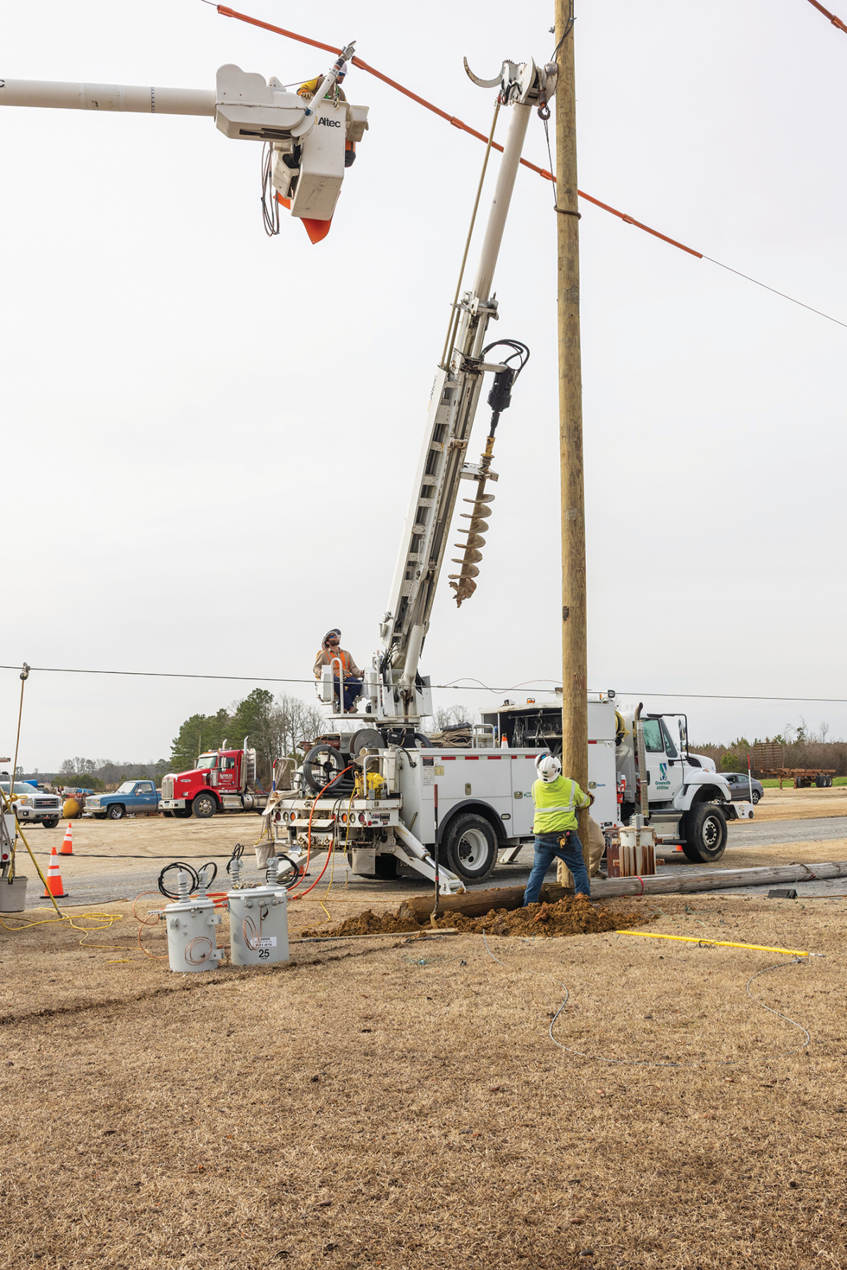 Lineworker First Class Richard Gould operates finishes boring a hole to install a new pole that is replacing an old one on David Nobles Road in Stokes.