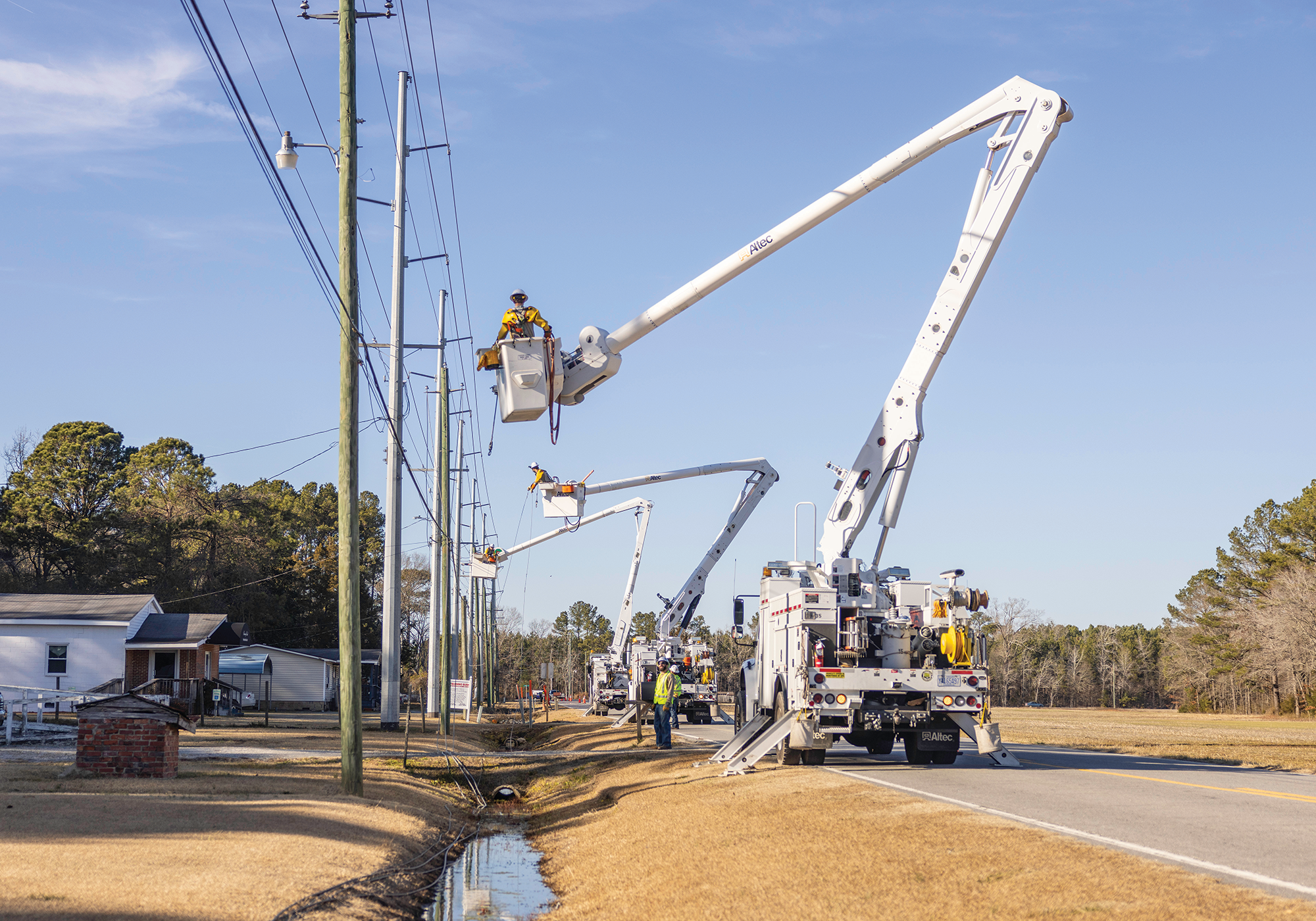 Electric OH Construction crews cut tops off of old poles after new ones were installed along Whichard Road.