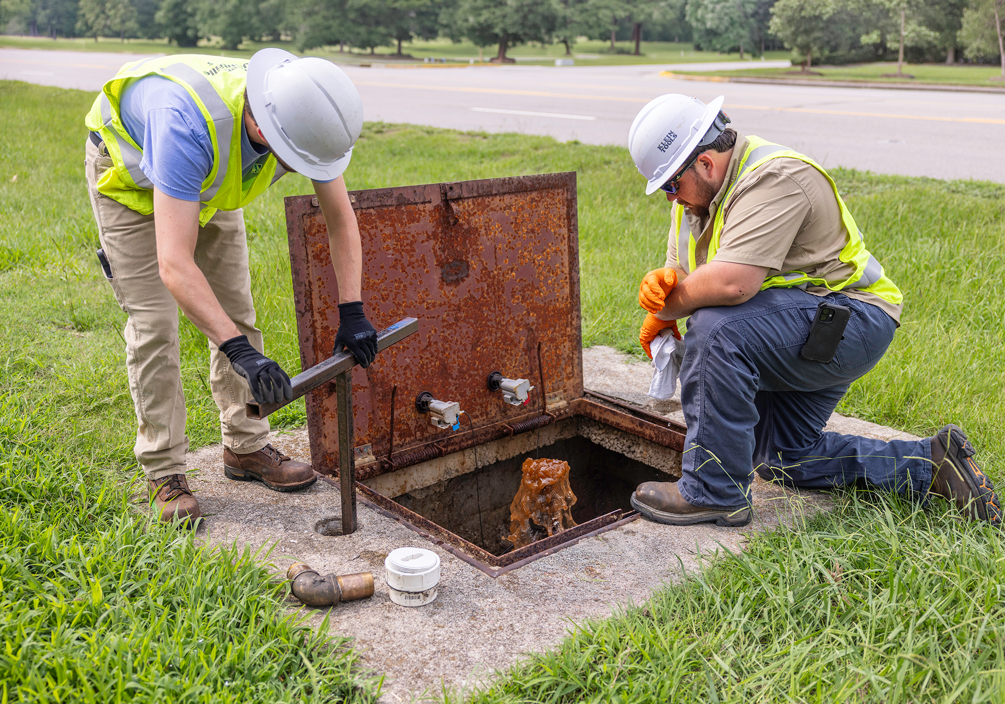 Systems O/M Techinican II Quentin Pool (left) and Water Systems O/M Crew Leader Dylan Morris (right) turn off a large water meter that services an apartment complex off of Charles Boulevard.