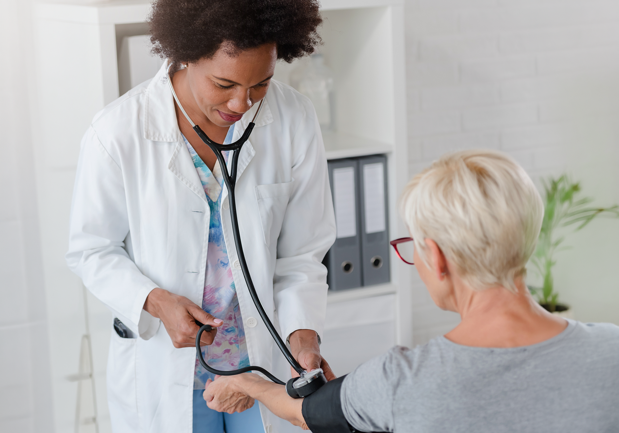 Doctor checking patients blood pressure