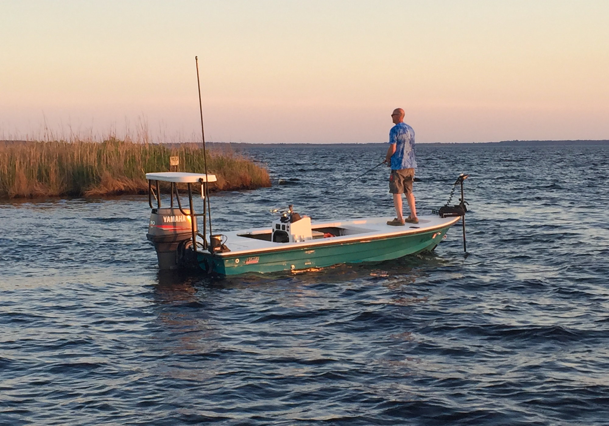 Man fishing during sunset