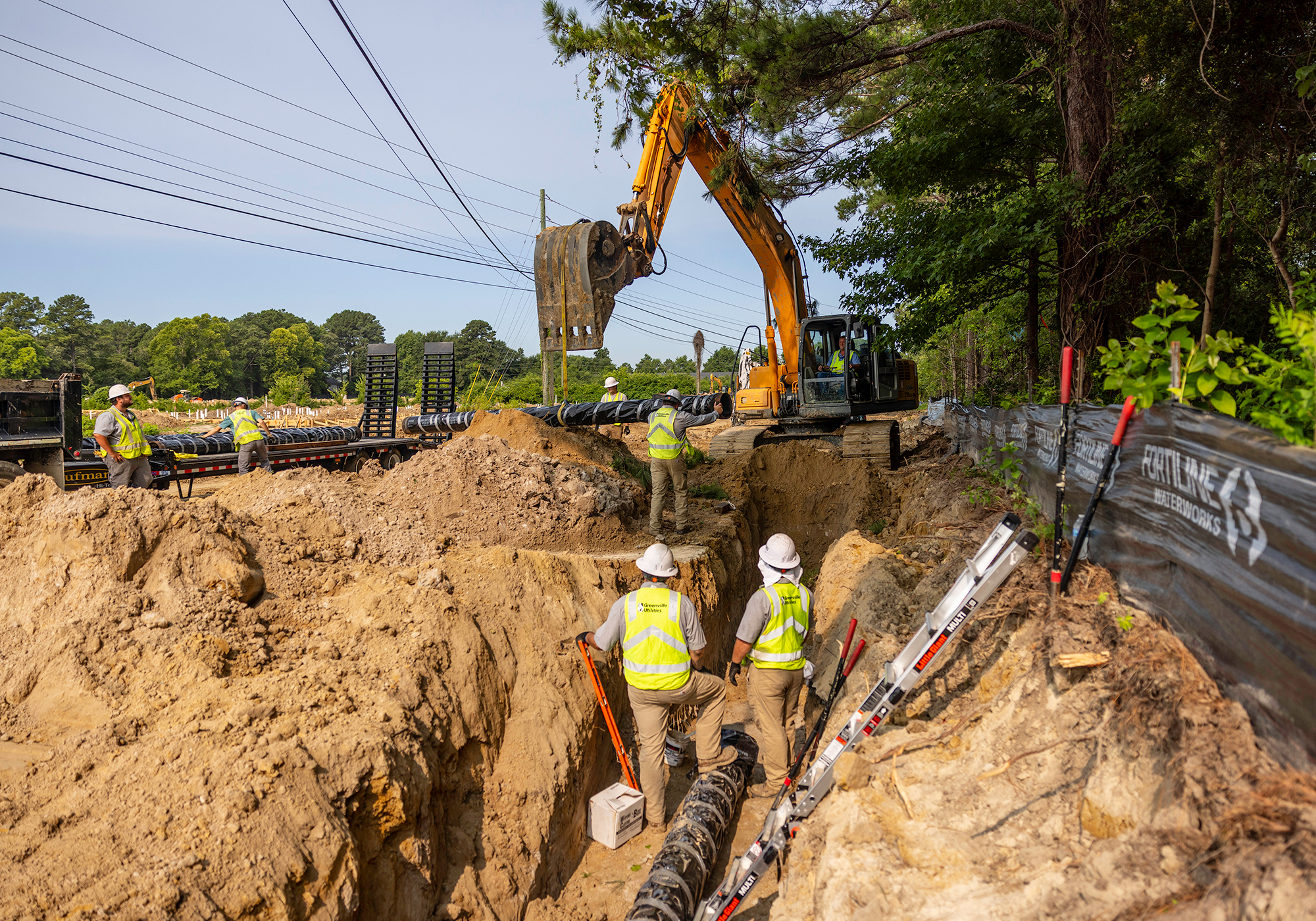 Service crews relocate and install a water main on Radio Station Road. 
