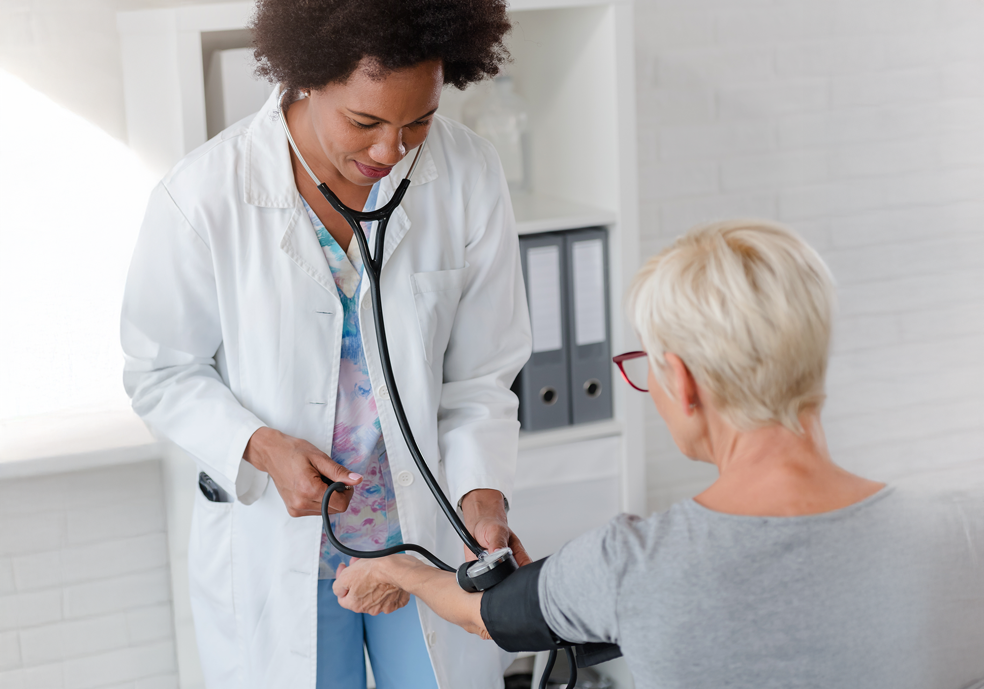 Doctor checks a patients blood pressure