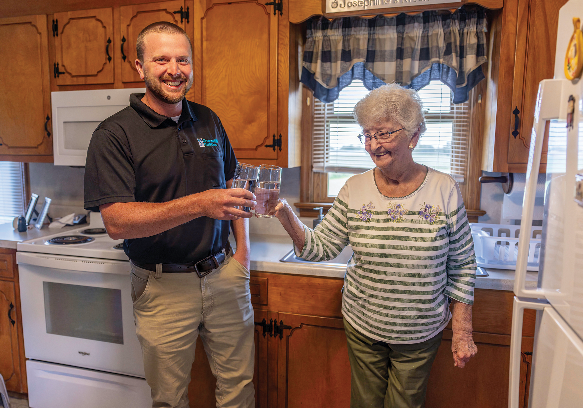 Water Resources Engineer I Tyler Haislip enjoys a glass of water with new customer Josephine Butler