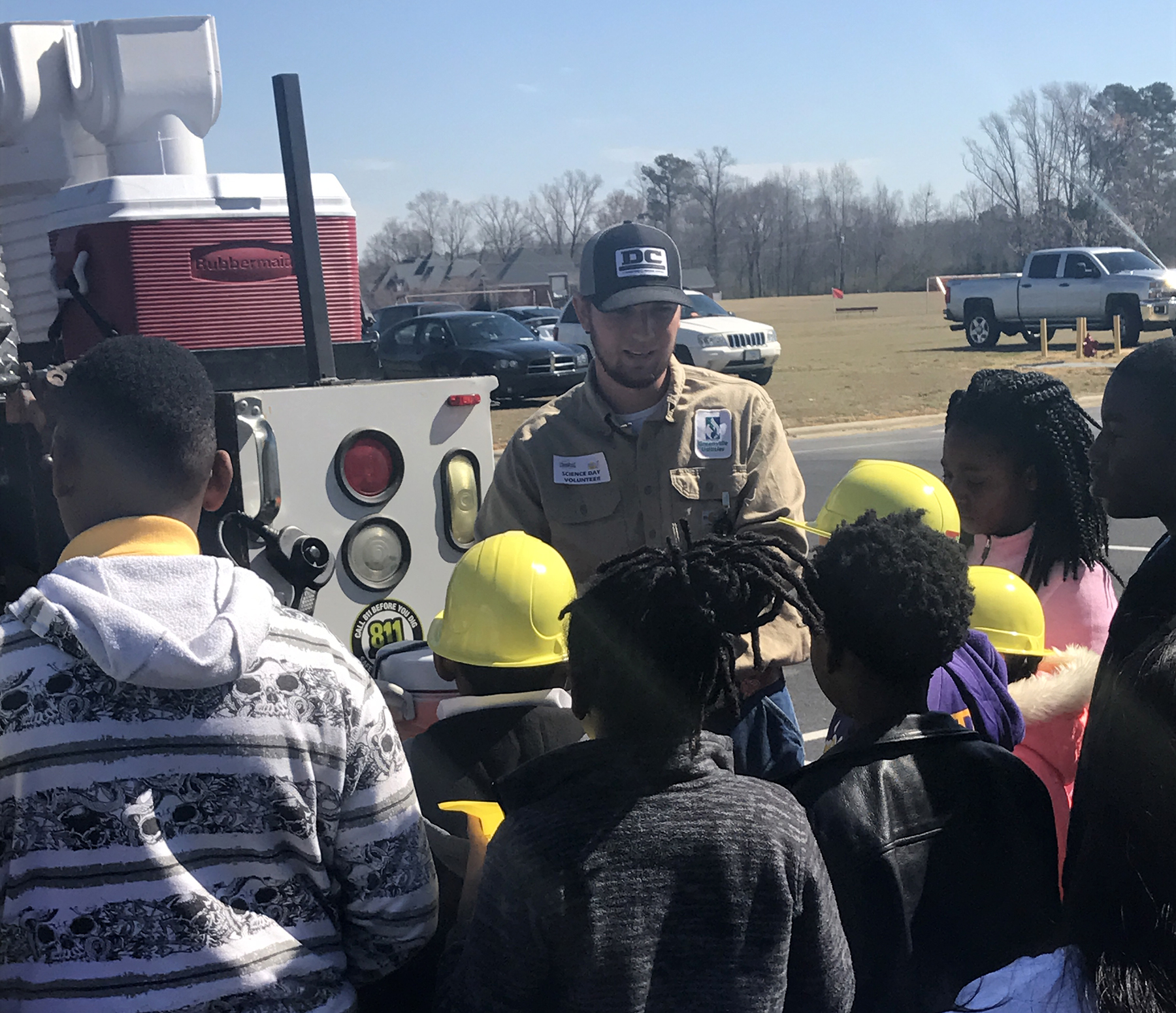 Paul Edwards talking with students by a truck.